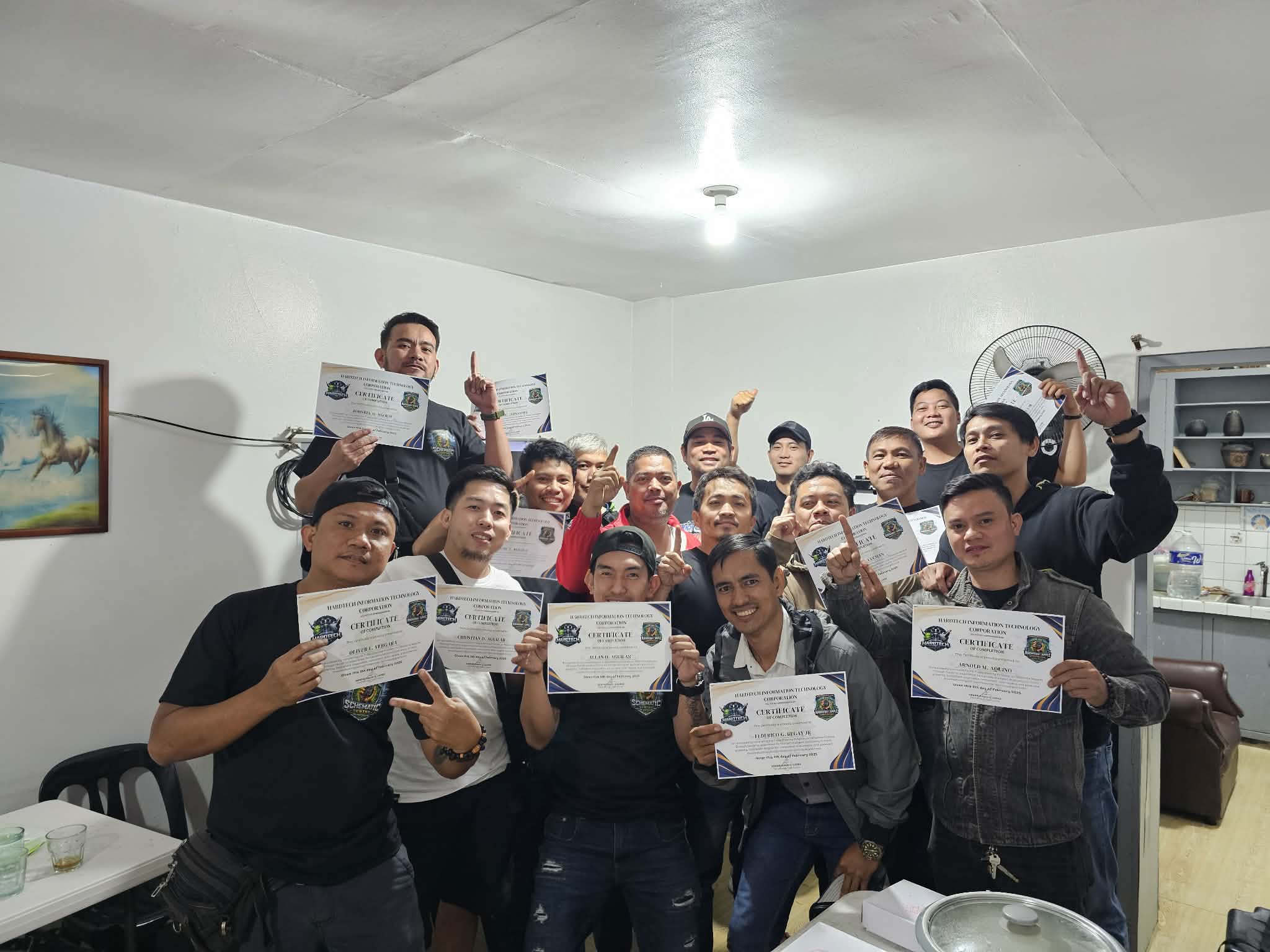 Group of graduates holding completion certificates.
